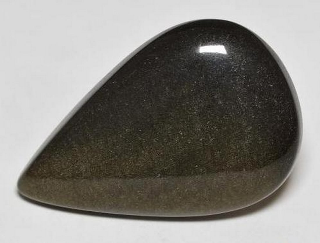 20.38ct Natural Black with Gold Sheen Obsidian, Pear, Opaque: 20.38ct Natural Black with Gold Sheen Obsidian, Pear, Opaque A natural black obsidian gemstone with a gold sheen, weighing 20.38 carats, cut in a pear cabochon shape with opaque clarity. The gem measu