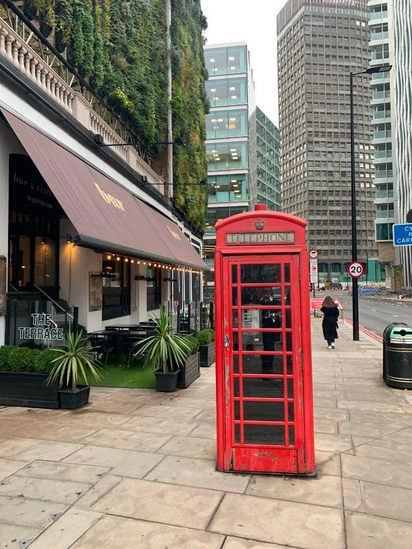 Iconic Red London Phone Booth: Iconic Red London Phone Booth Bring a touch of classic London charm into your home with this exclusive hand-painted canvas opportunity. The photograph captures a vibrant red phone booth standing