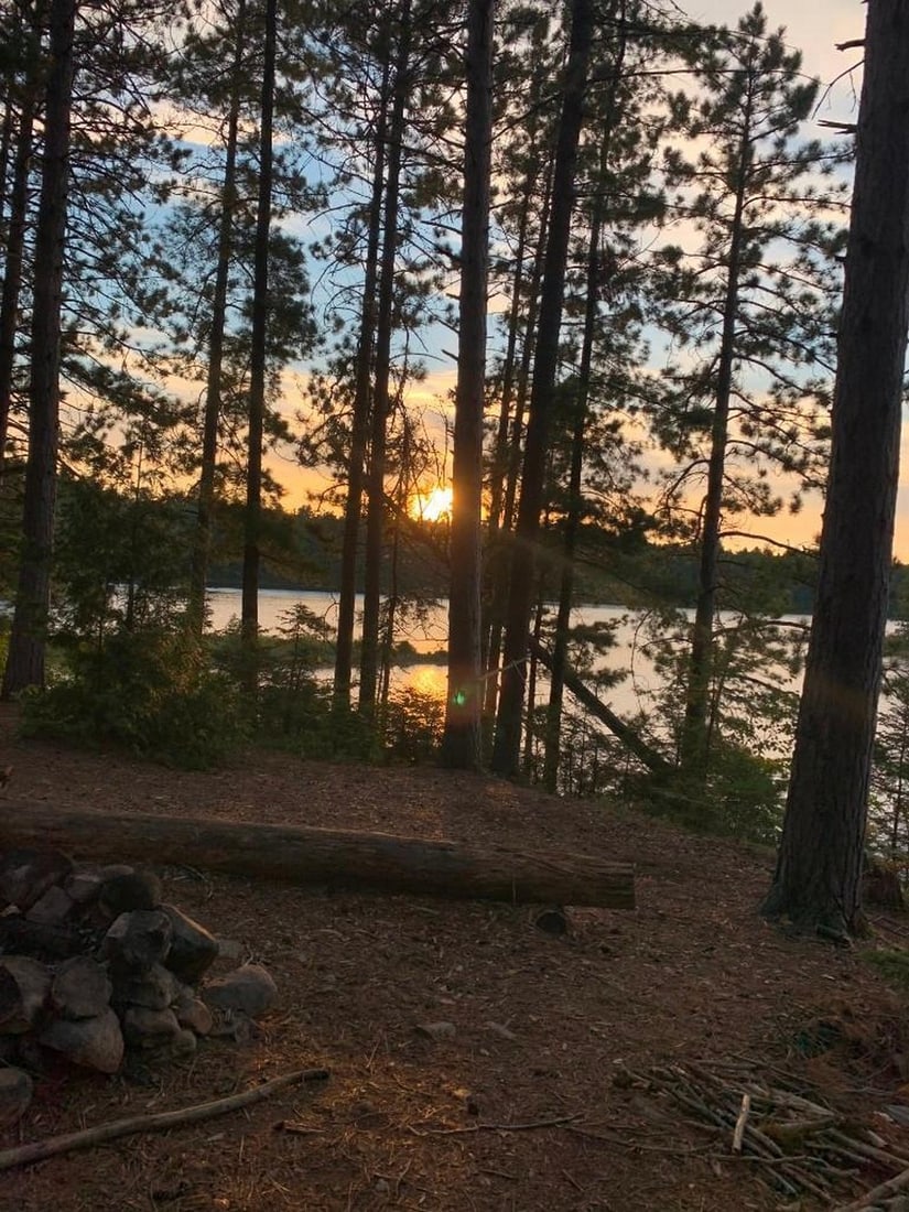 Twilight Camp: Twilight Camp Experience the quiet magic of the wilderness with this hand-painted canvas opportunity. The photograph captures a campsite tucked among the trees, with a firepit waiting for evening