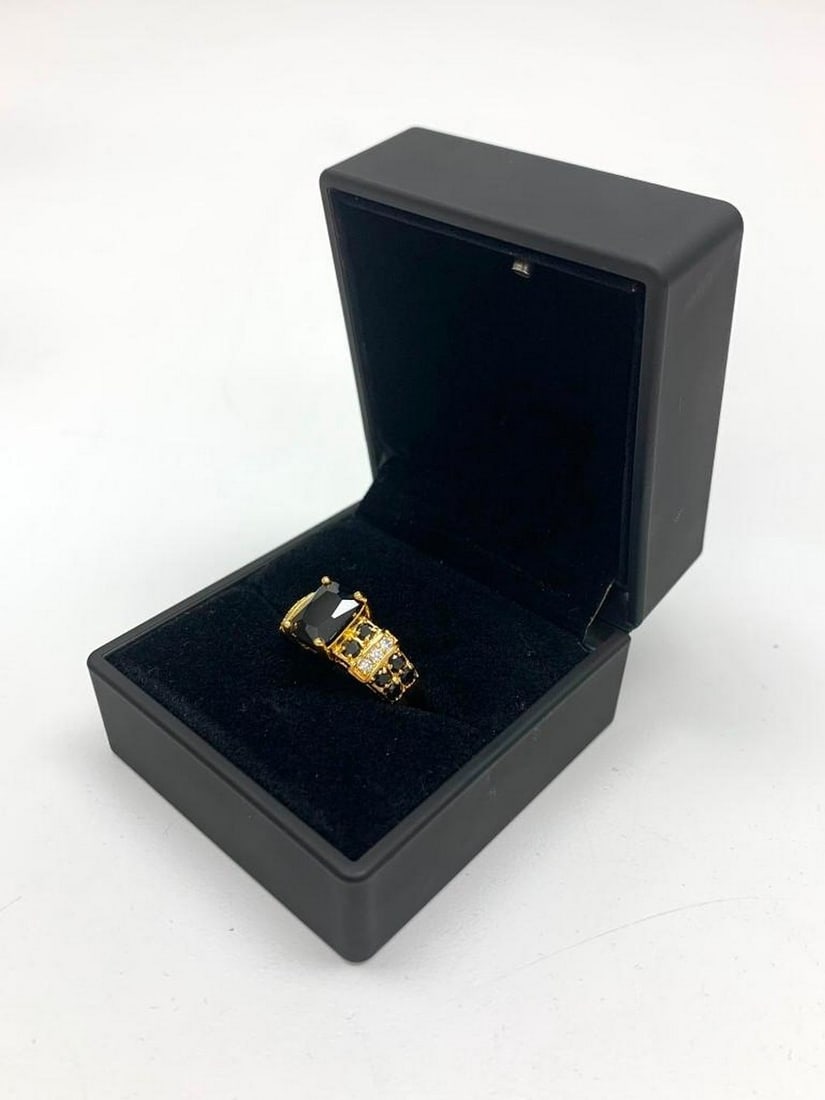 Black Stone Ring: Black Stone Ring Make a statement with this stunning ring featuring a bold black stone at its center. The band is elegantly lined with alternating black and white crystals on either side, adding