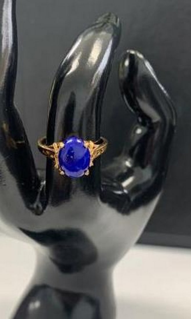 Oval Deep Blue Stone Ring: Oval Deep Blue Stone Ring Add sophistication to your style with this striking 18KTGP yellow gold electroplated ring, featuring a large oval-cut blue stone at its center. The vibrant stone