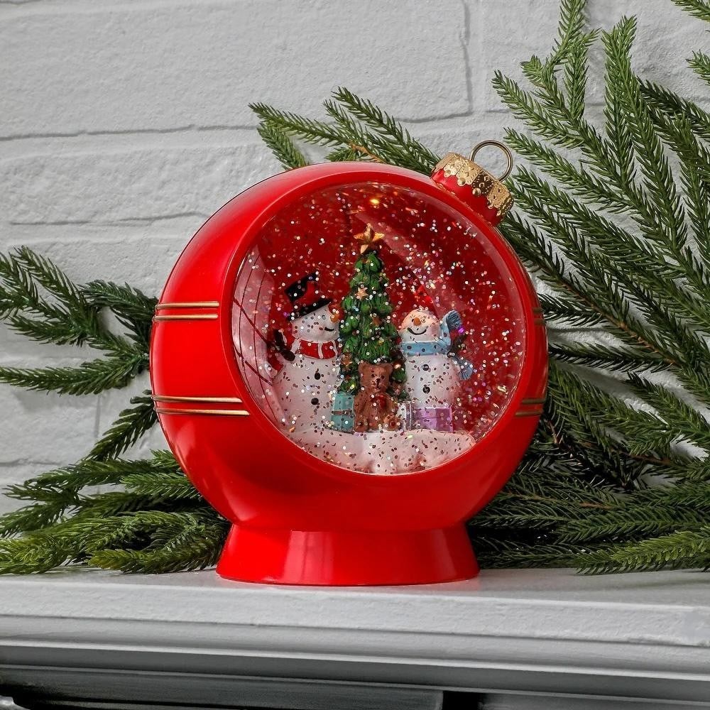 Winter Magic LED Snowman Ornament Globe: Winter Magic LED Snowman Ornament Globe Add a festive touch to your holiday décor with this 6" LED Snowman Ornament Water Globe. A cheerful snowman scene inside is surrounded by swirling glitter