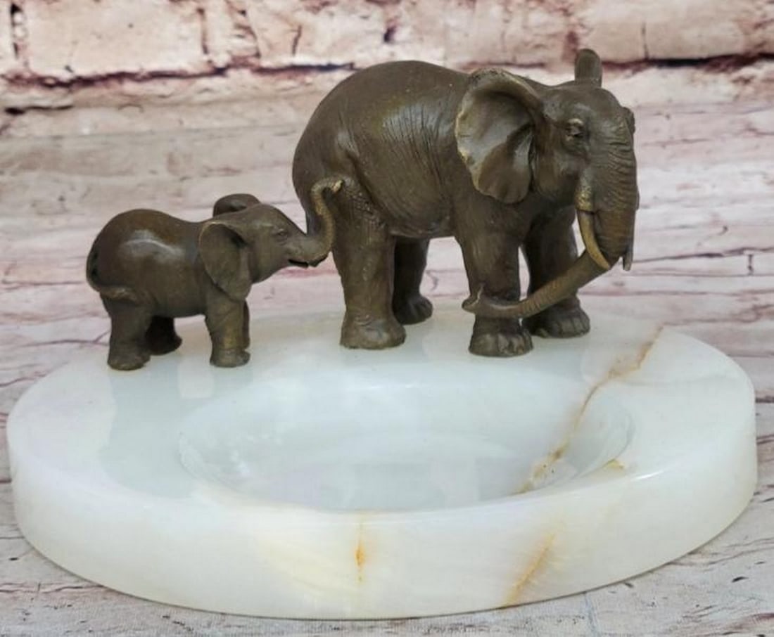 Bronze Elephant Mother & Calf on Marble Soap Base: Bronze Elephant Mother & Calf on Marble Soap Base Tender and timeless, this bronze sculpture depicts a touching scene of an elephant mother gently guiding her calf, capturing the deep bond and pr
