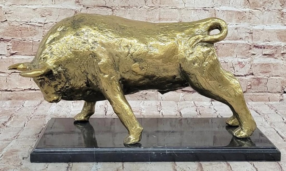 Golden Strength: Bull Bronze Sculpture: Golden Strength: Bull Bronze Sculpture A bold symbol of power and determination, this striking bronze sculpture features a dynamic bull, rendered with strong musculature and a commanding presence. Fi