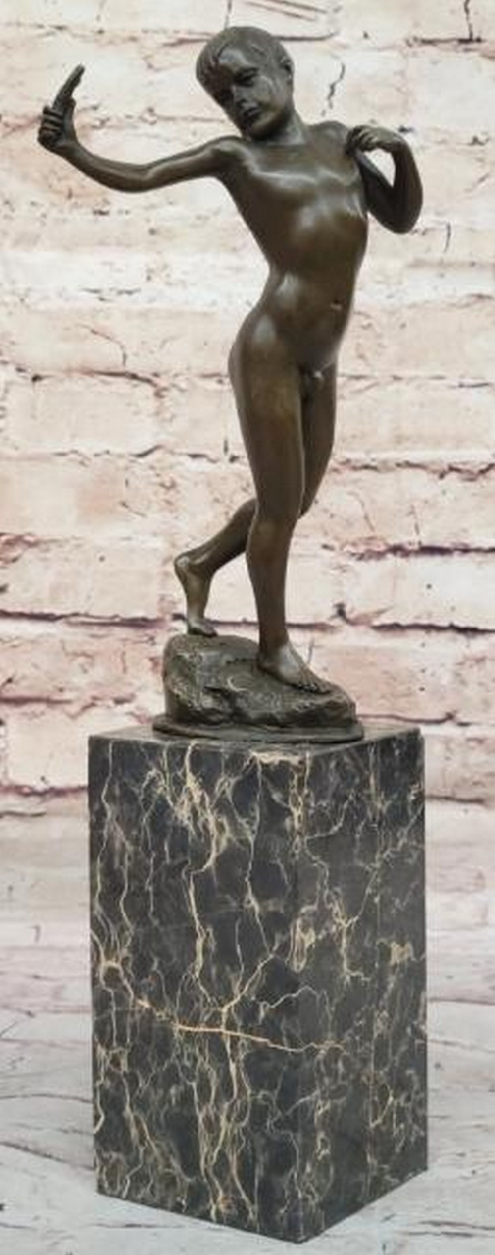 Warrior Poise: Nude Male Figure with Sling Bronze Sculpture: Warrior Poise: Nude Male Figure with Sling Bronze Sculpture Evoking the timeless strength and agility of ancient warriors, this bronze sculpture features a nude male figure poised with a sling in han