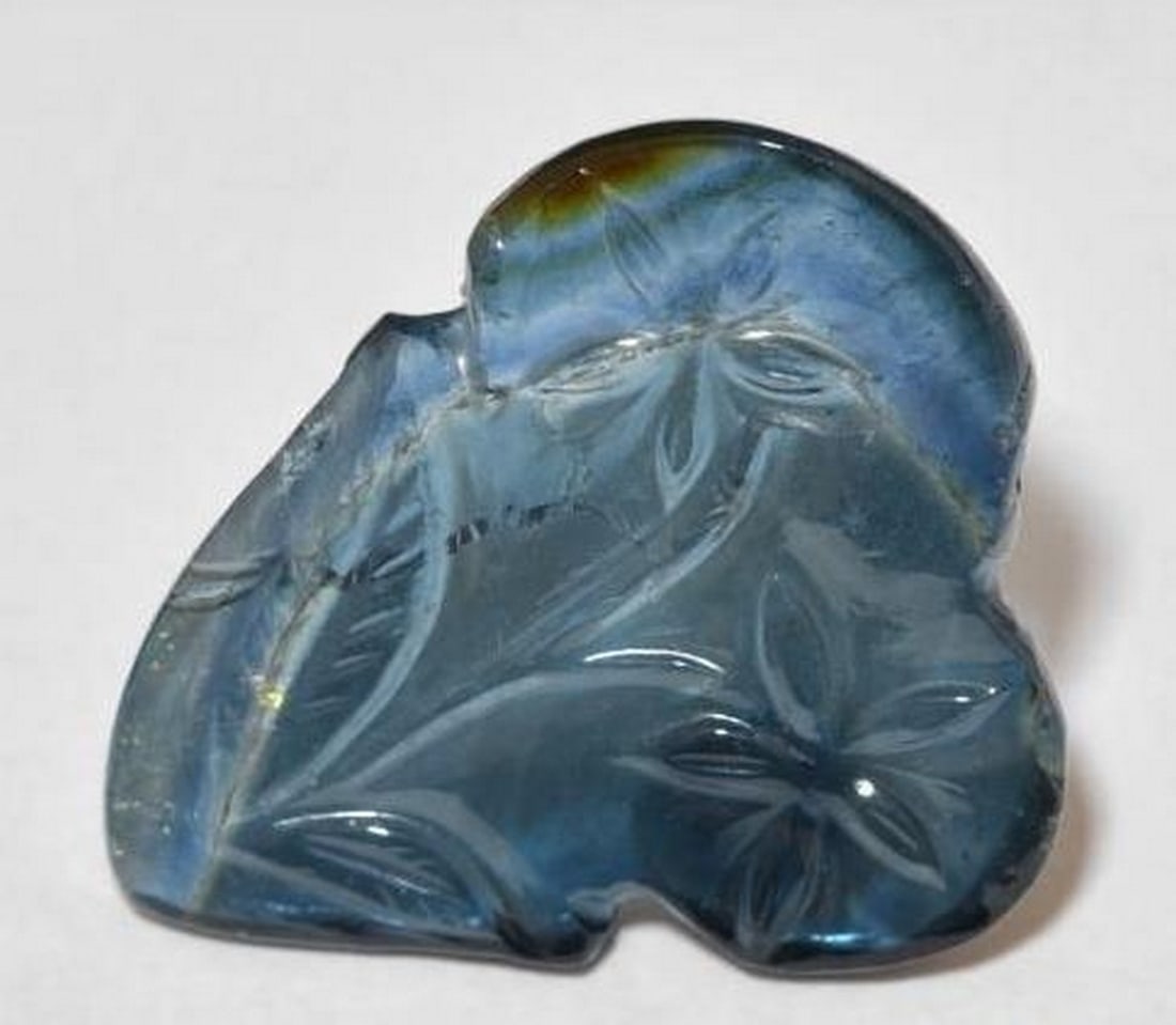 Loose Tourmaline Gemstone Deep Navy Blue Hand-Carved Flower Design: Loose Tourmaline Gemstone Deep Navy Blue Hand-Carved Flower Design Graceful and unique, this loose Tourmaline gemstone is expertly carved into an intricate flower design, showcasing a rich navy