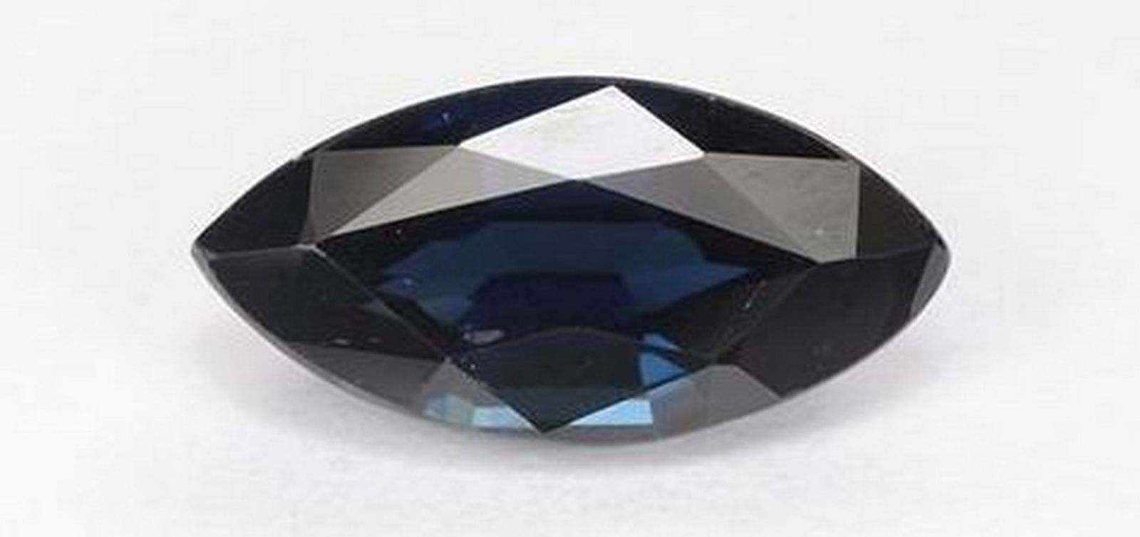 Midnight Blue Sapphire Marquise Faceted Gemstone: Midnight Blue Sapphire Marquise Faceted Gemstone Elegant and alluring, this marquise-cut sapphire shimmers with a deep midnight blue hue that evokes the mystery of a starlit sky. The elongated