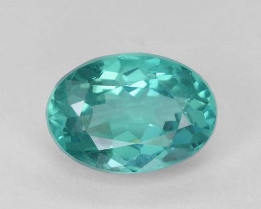 5.33 ct Natural Bright Teal Apatite, Oval Facet, VS, Madagascar: 5.33 ct Natural Bright Teal Apatite, Oval Facet, VS, Madagascar Natural apatite weighing 5.33 carats, cut in an oval faceted form with a vivid bright teal color. The gemstone measures 12.48 x 8.87 x