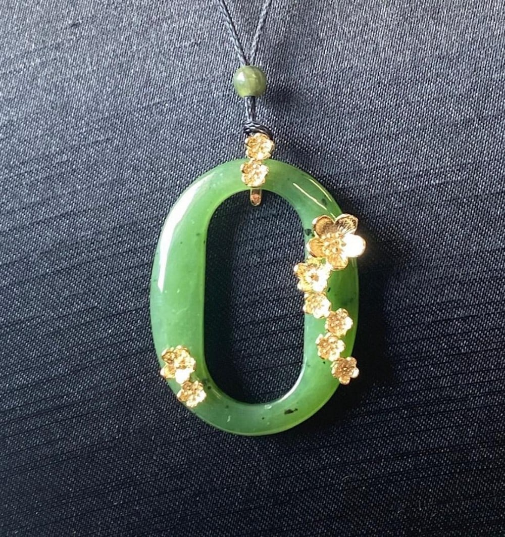Canadian Nephrite Jade Oval Nephrite Pendant: Canadian Nephrite Jade Oval Nephrite Pendant This pendant is crafted from genuine Canadian Nephrite Jade and features an elegant oval shape. It is designed with a polished finish that highlights the