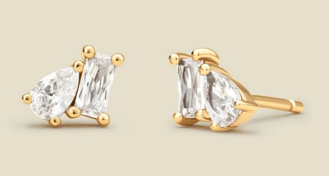 Vermeil Gold & CZ Toi et Moi Stud Earrings: Vermeil Gold & CZ Toi et Moi Stud Earrings These elegant stud earrings showcase a classic pairing of emerald and pear-cut CZs, bringing a radiant glow to your everyday style. A subtle reminder