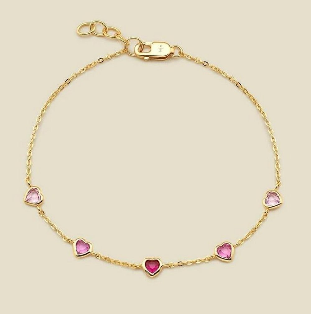 Golden Heart Ombre Bracelet: Golden Heart Ombre Bracelet Wear your heart with elegance in the Golden Heart Ombre Bracelet. Featuring floating CZ hearts in soft, graduating pink hues, this delicate piece adds a touch of romance