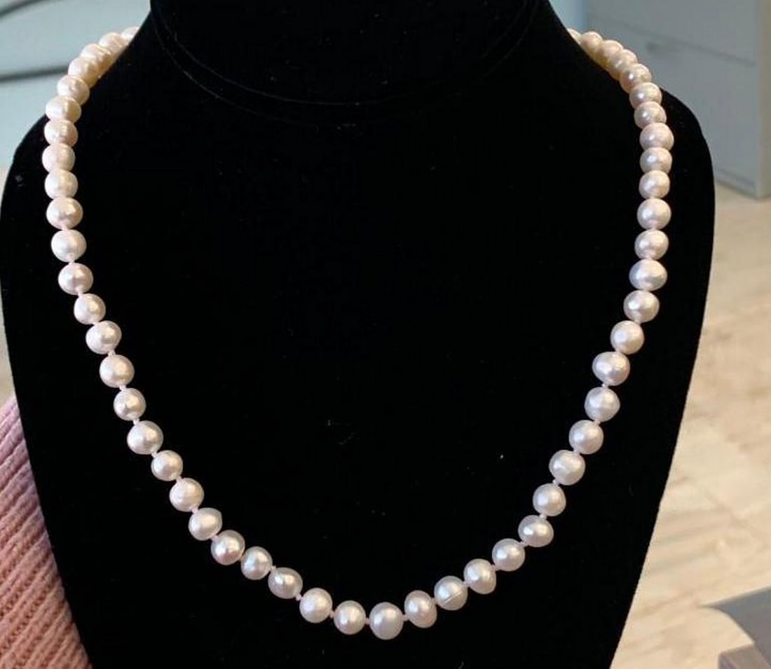 Classic White Pearl Strand with Sterling Silver Clasp: Classic White Pearl Strand with Sterling Silver Clasp This elegant pearl necklace showcases a strand of luminous white pearls secured with a sterling silver clasp. The simplicity of the design highli