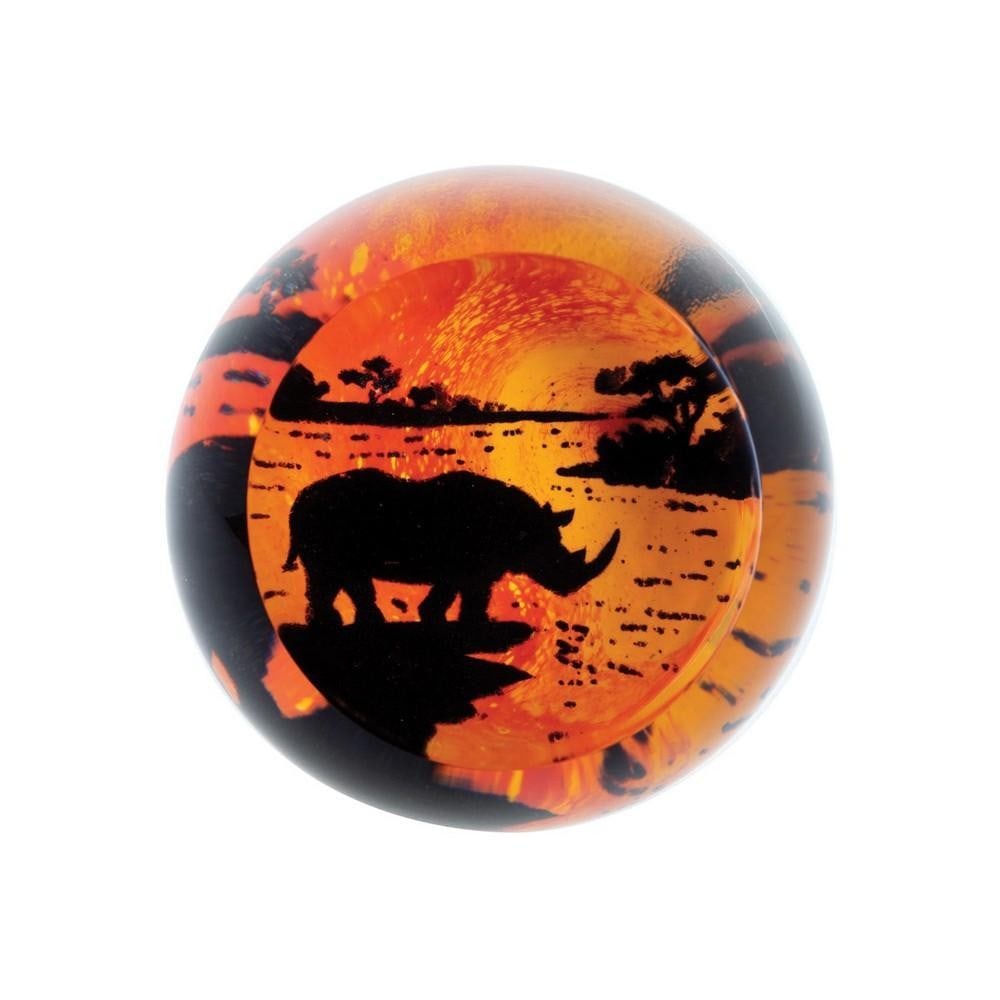 Savannah Rhino Paperweight: Savannah Rhino Paperweight A glass paperweight capturing a rhino grazing by a marsh within a stylized African landscape. The detailed design highlights the animal’s strength and presence, while the