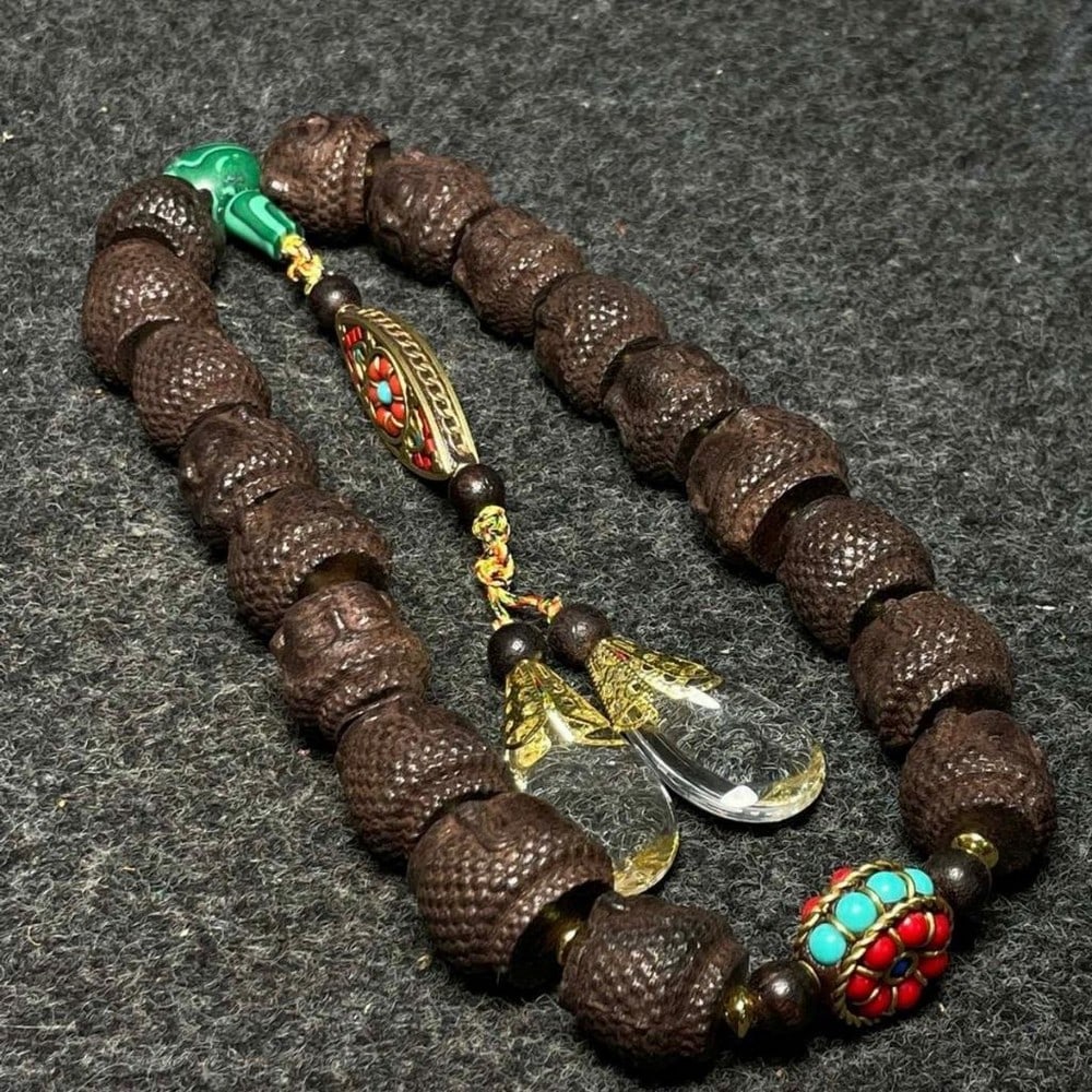 Agarwood Carved Eighteen Beads Buddha Head Bracelet: Agarwood Carved Eighteen Beads Buddha Head Bracelet This unique bracelet features eighteen finely carved agarwood beads, each shaped as a serene Buddha head, symbolizing mindfulness, protection,