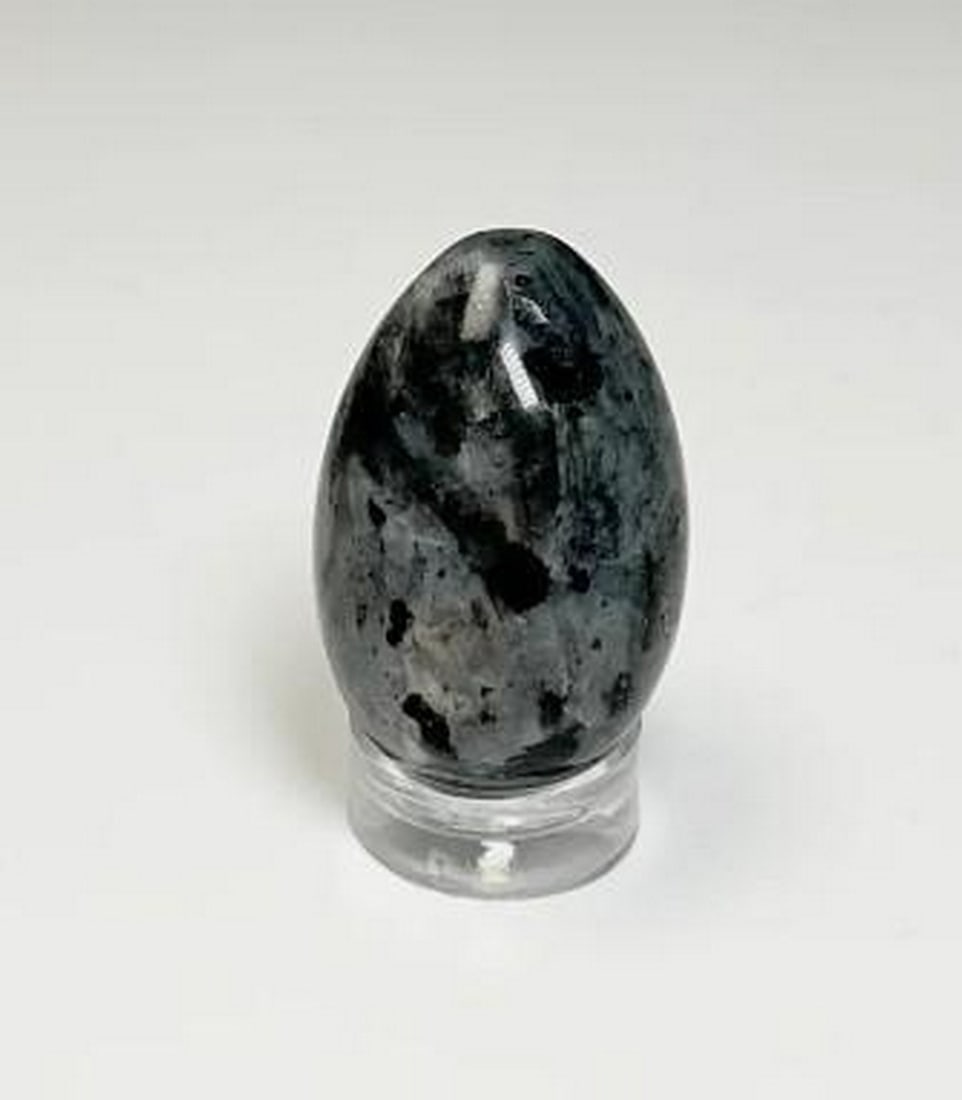 Mystic Stone Larvikite Mini Egg: Mystic Stone Larvikite Mini Egg The Mystic Stone Larvikite Mini Egg captivates with its shimmering, dark-gray surface, flecked with luminous blue and silver accents. Known for its grounding and