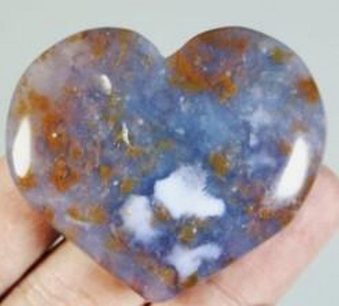 Polished Ocean Jasper Heart with Agate and Quartz Inclusions: Polished Ocean Jasper Heart with Agate and Quartz Inclusions This heart-shaped palm stone features the natural beauty of ocean jasper, accented by flowing agate bands and delicate quartz