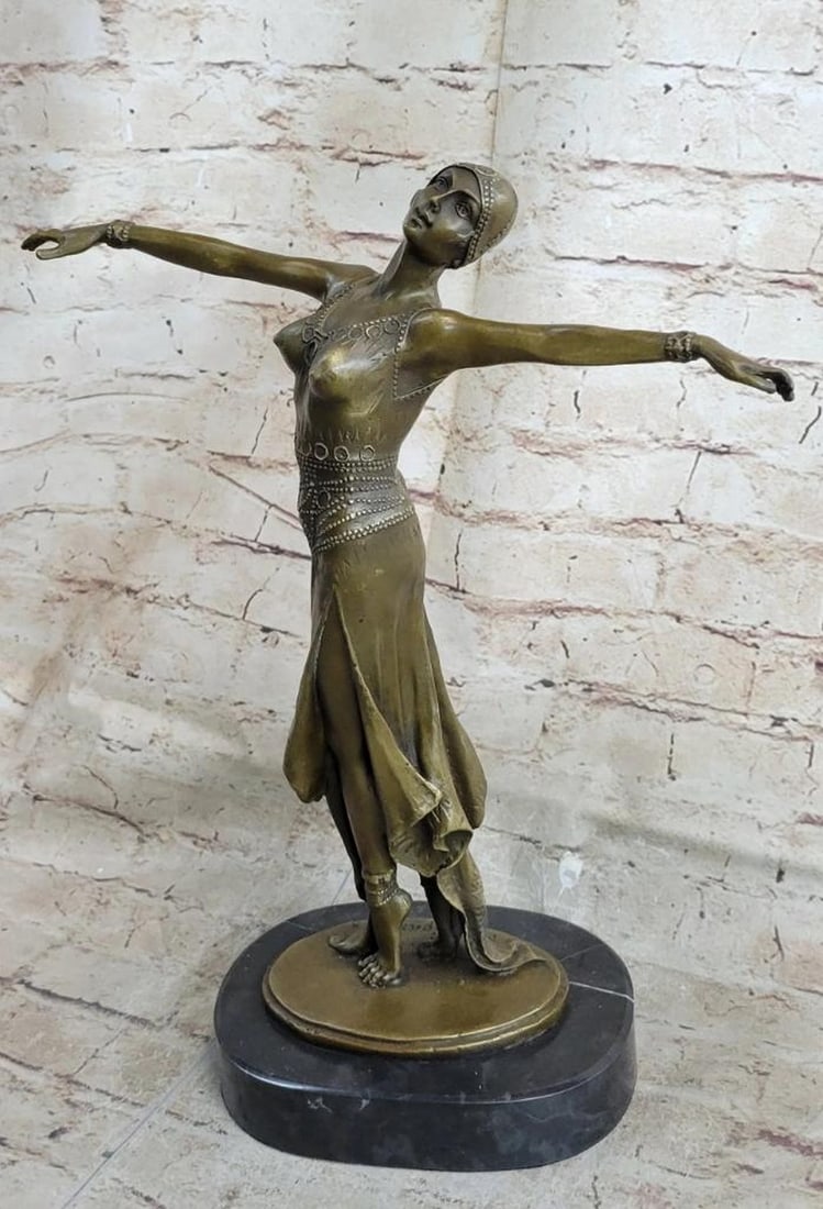 Bronze Sculpture Dancer Standing On Her Toes Bronze Sculpture On Marble Base - 11lbs: The admirable dancer balances gracefully on her toes. She extends her arms in second position tilting her head. She is a vision of artistic movement dressed in a Russian dance costume that highlights