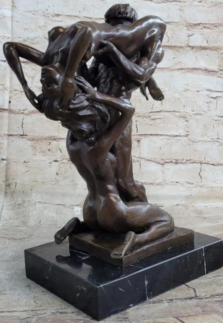 Trinity of Passion Intimate Nude Bronze Sculpture: Trinity of Passion Intimate Nude Bronze Sculpture This evocative bronze sculpture captures a deeply intimate scene between three nude figures, one male and two females, entwined in a moment of shared