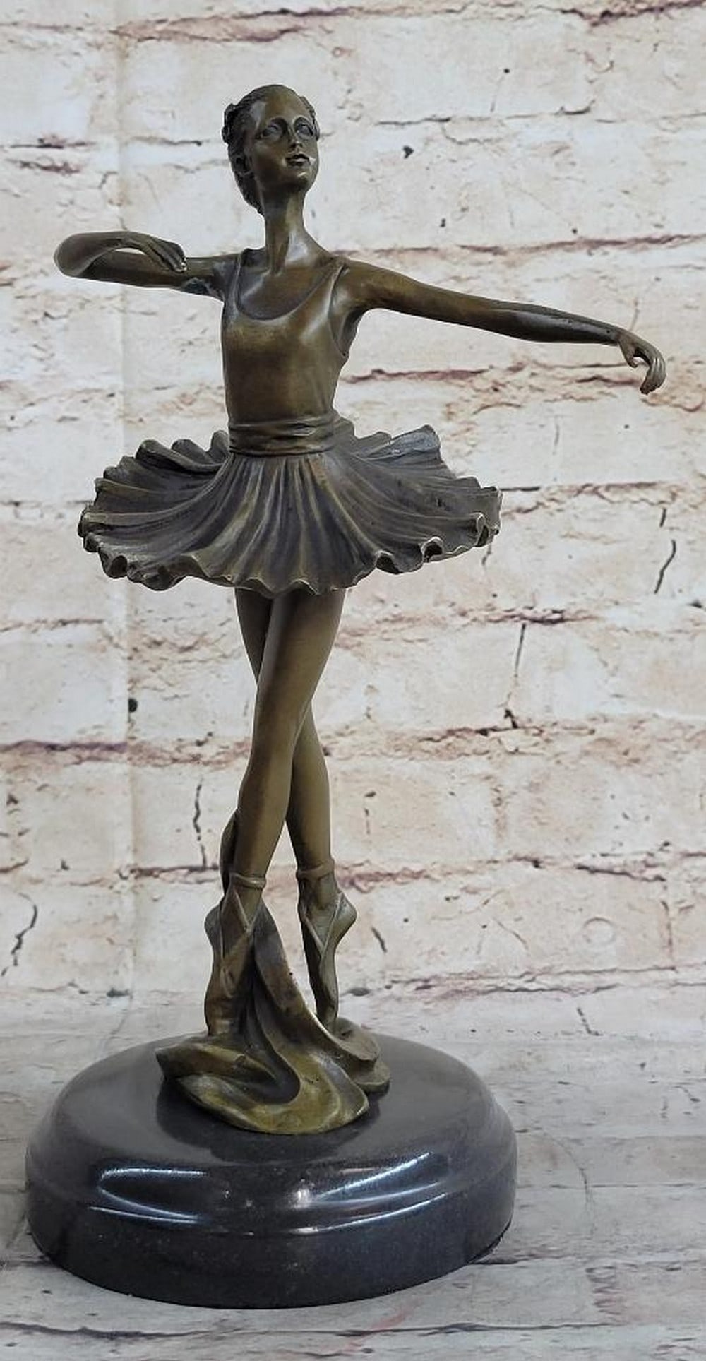 En Pointe Ballerina Bronze Sculpture - 11" x 6": En Pointe Ballerina Bronze Sculpture - 11" x 6" This enchanting bronze sculpture captures the grace of a young ballerina en pointe, arms open wide in a graceful pose. Intricate details in her
