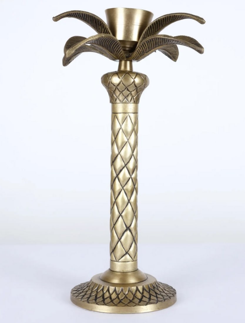 Brass Palm Tree Candle Holder – 13": Brass Palm Tree Candle Holder – 13" A 13-inch brass candle holder designed in the shape of a palm tree. The statue features stylized fronds and a textured trunk, providing a sculptural base for a ca