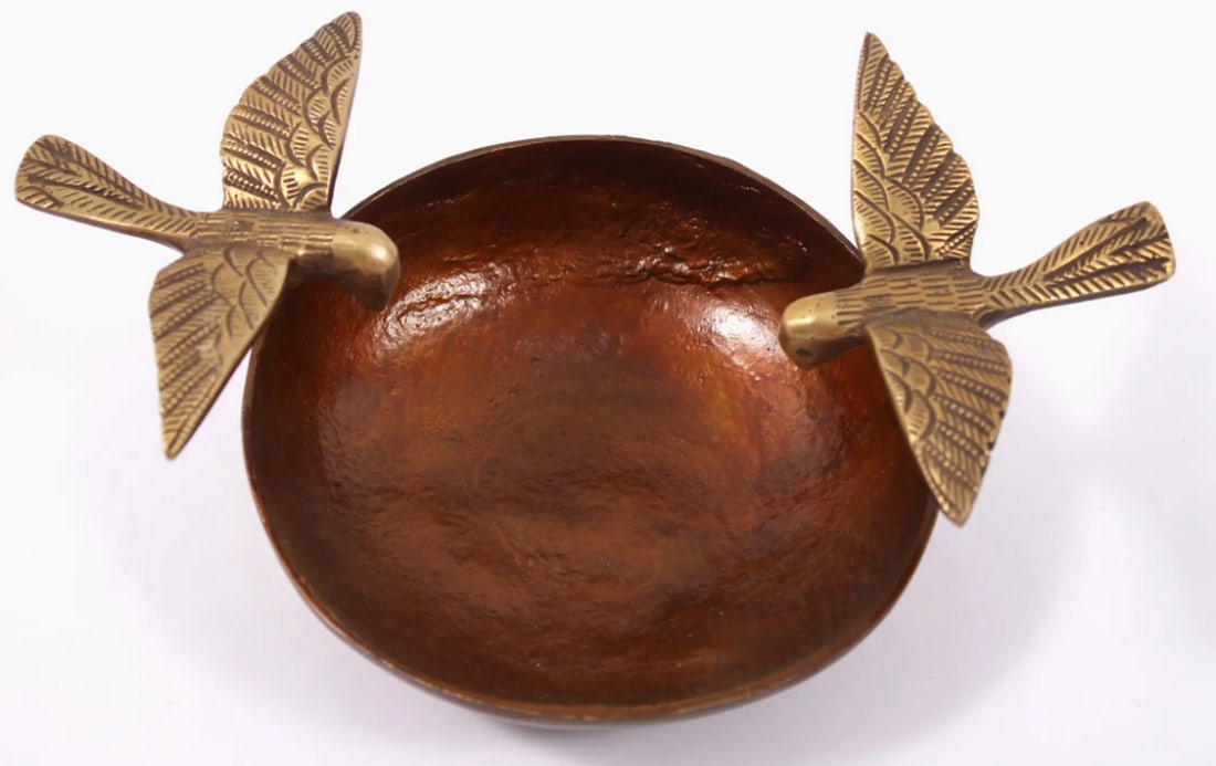 8" Brass Urli Bowl with Flying Bird: 8" Brass Urli Bowl with Flying Bird Brass urli with a burned copper finish, featuring birds perched along the outer circle. Minimalistic design emphasizes elegance and simplicity, making it a capt