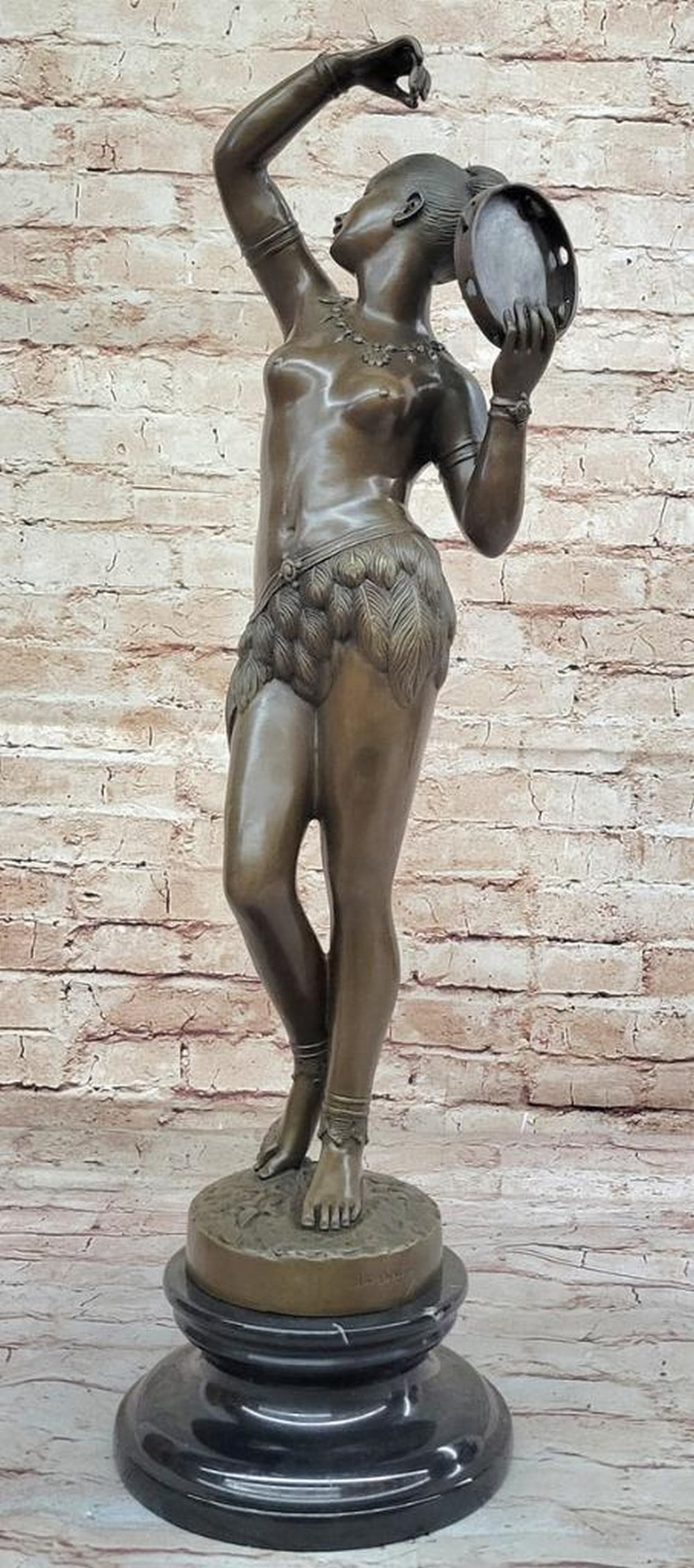 M.C. Bouay's Dancer of Tambourine Inspired Bronze Sculpture on Marble Base - 24.5" x 7": M.C. Bouay's Dancer of Tambourine Inspired Bronze Sculpture on Marble Base - 24.5" x 7" Experience the enchanting allure of M.C. Bouay's Dancer of Tambourine Bronze Sculpture, a mesme