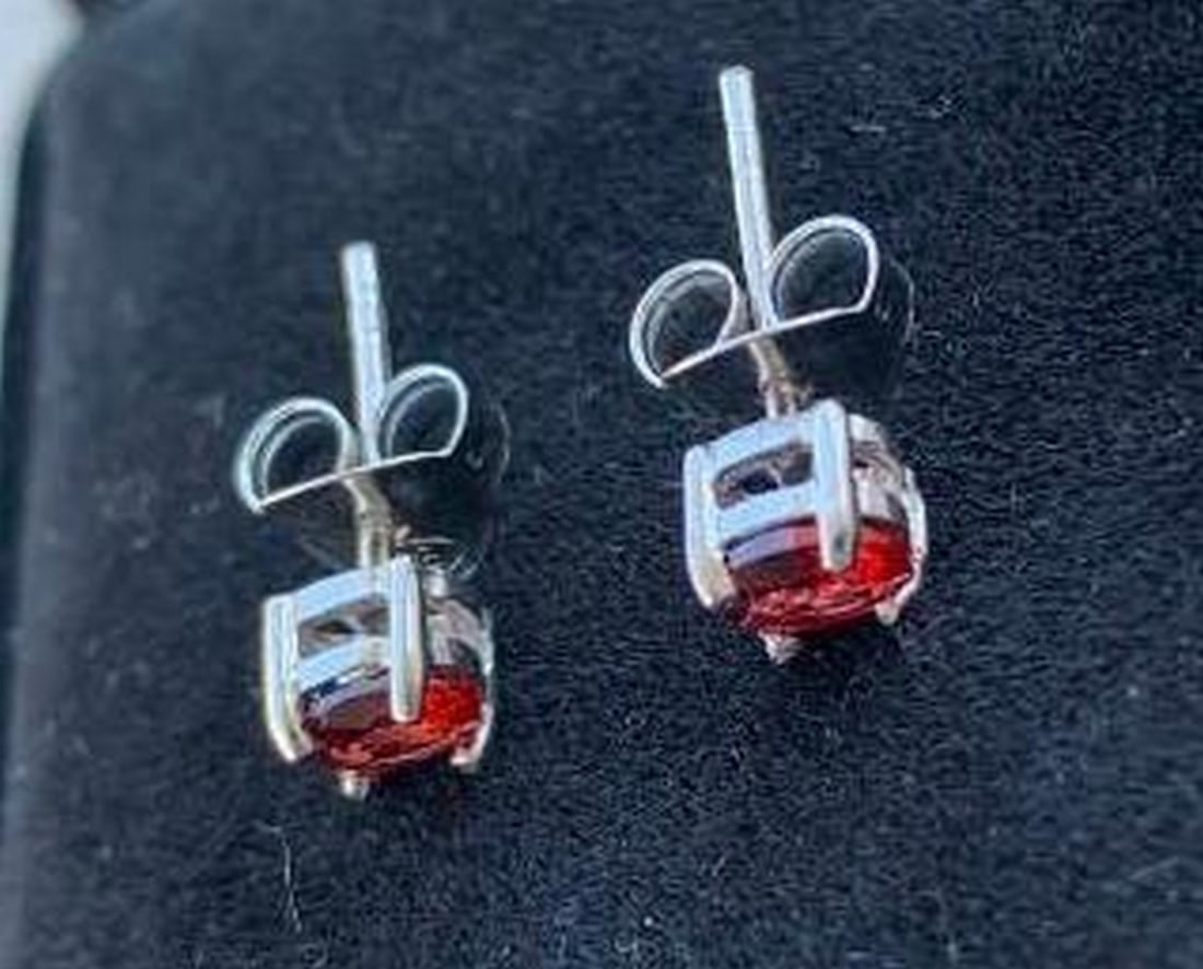 Scarlet Glow: Sterling Silver Red Stone Studs: Scarlet Glow: Sterling Silver Red Stone Studs Make a statement with these stunning stud earrings featuring vibrant red stones set in sterling silver. The rich, fiery color adds the perfect dash of dr