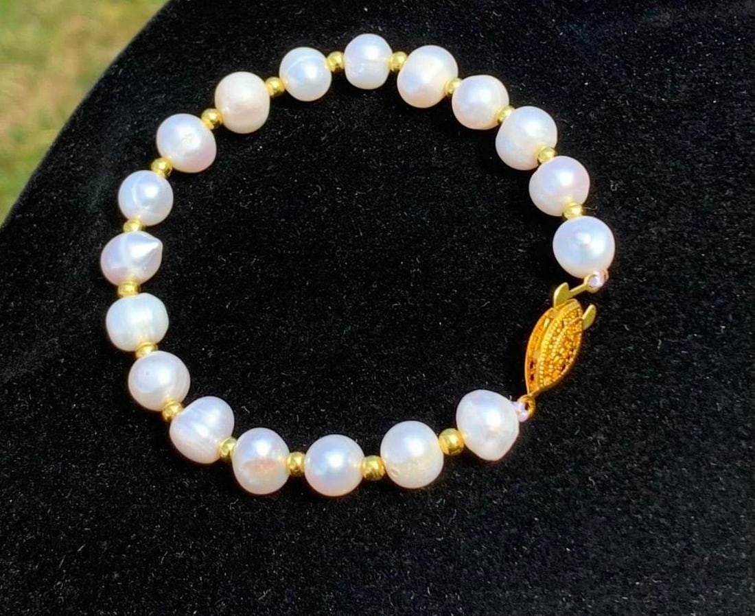 Pearl Bracelet with Gold-Tone Bead Accents: Pearl Bracelet with Gold-Tone Bead Accents Classic elegance meets modern charm in this beautifully designed pearl bracelet. Pearls are delicately spaced with small gold-colored beads, adding a warm t