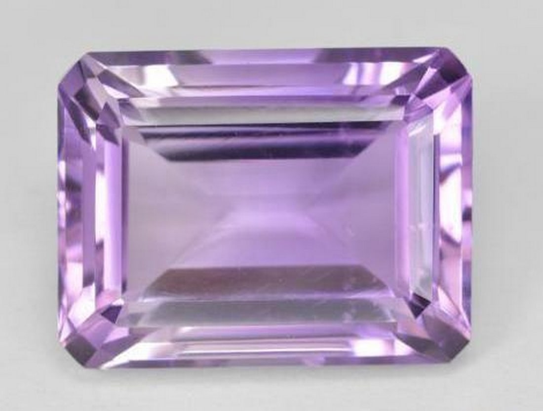 18.1ct Octagon Step Cut Subtle Medium Violet Amethyst Gemstone: 18.1ct Octagon Step Cut Subtle Medium Violet Amethyst Gemstone Introducing our 18.1ct Octagon Step Cut Subtle Medium Violet Amethyst Gemstone, a mesmerizing testament to refined elegance. This