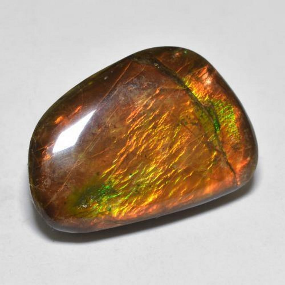 16ct Canadian Ammolite Gemstone: 16ct Canadian Ammolite Gemstone Raw Dimension: 20 x 14 x 5mm Total Carat Weight: 16.39ct Treated: No Please view photos for further details.