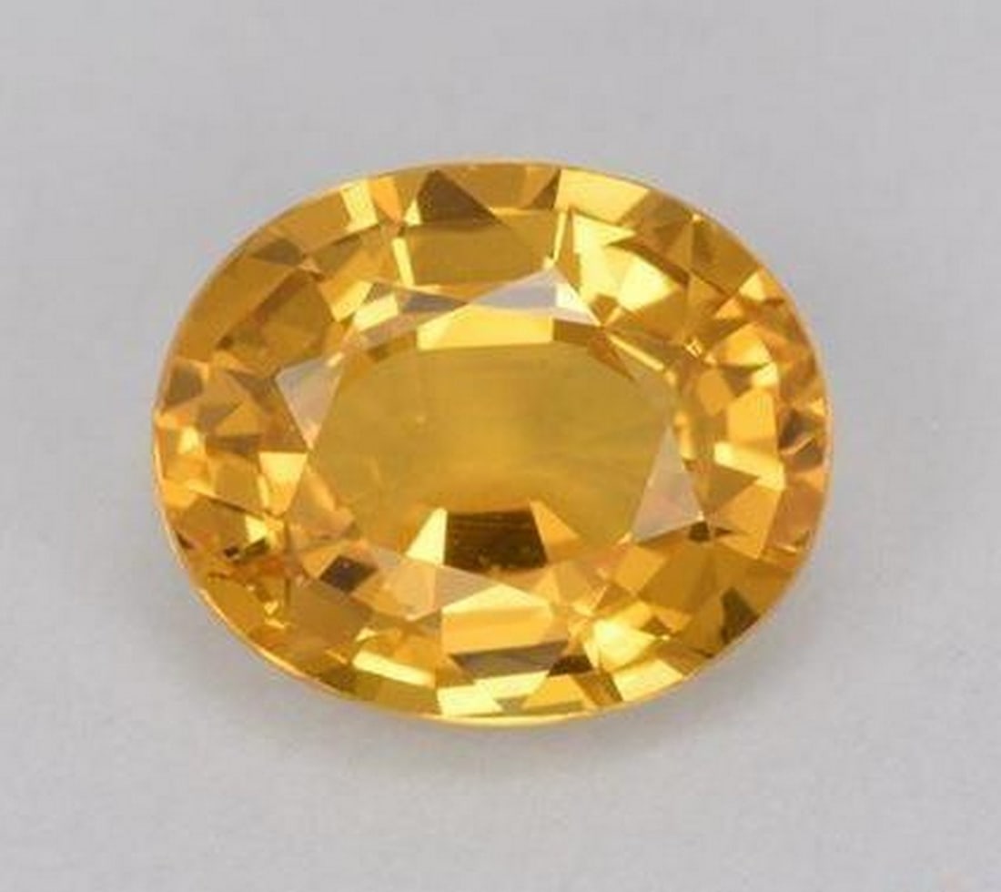 1.3ct Oval Cut Faceted Dark Golden Sun Yellow Sapphire Gemstone: 1.3ct Oval Cut Faceted Dark Golden Sun Yellow Sapphire Gemstone Introducing our stunning 1.3ct Oval Cut Faceted Dark Golden Sun Yellow Sapphire Gemstone – a radiant testament to warmth and sophisti