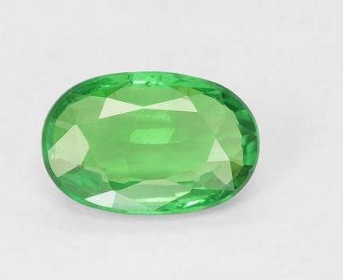 0.89 ct Oval Cut Faceted Shamrock Green Tsavorite Garnet: 0.89 ct Oval Cut Faceted Shamrock Green Tsavorite Garnet Step into the enchanting realm of the Oval Cut Faceted Shamrock Green Tsavorite Garnet, a gemstone that radiates the vibrant spirit of lush me