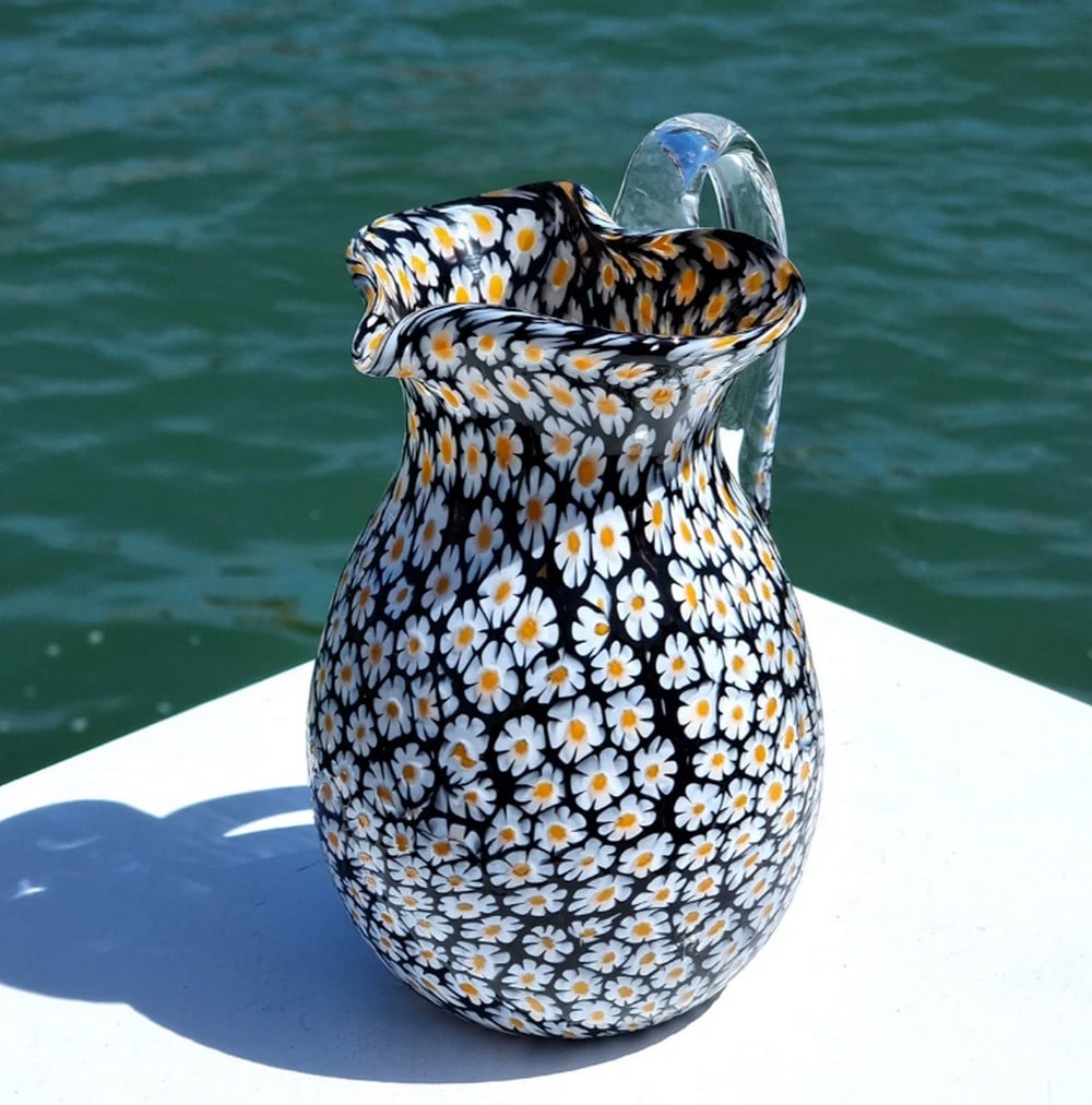 Millefiori Daisy Murano Glass Pitcher: Millefiori Daisy Murano Glass Pitcher This carafe is expertly crafted using the traditional glassblowing technique, featuring intricate murrina decoration with small glass pieces that add vibrant col