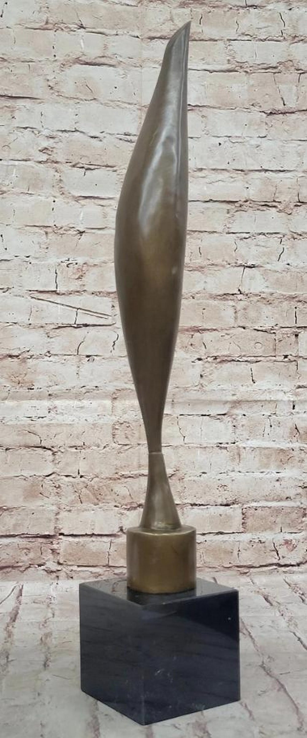 Bird in Space" Inspired Bronze Statue - 23" x 4: "Bird in Space" Inspired Bronze Statue - 23" x 4" The bronze statue in the image is an elegant representation inspired by “Bird in Space,” characterized by its tall, slender