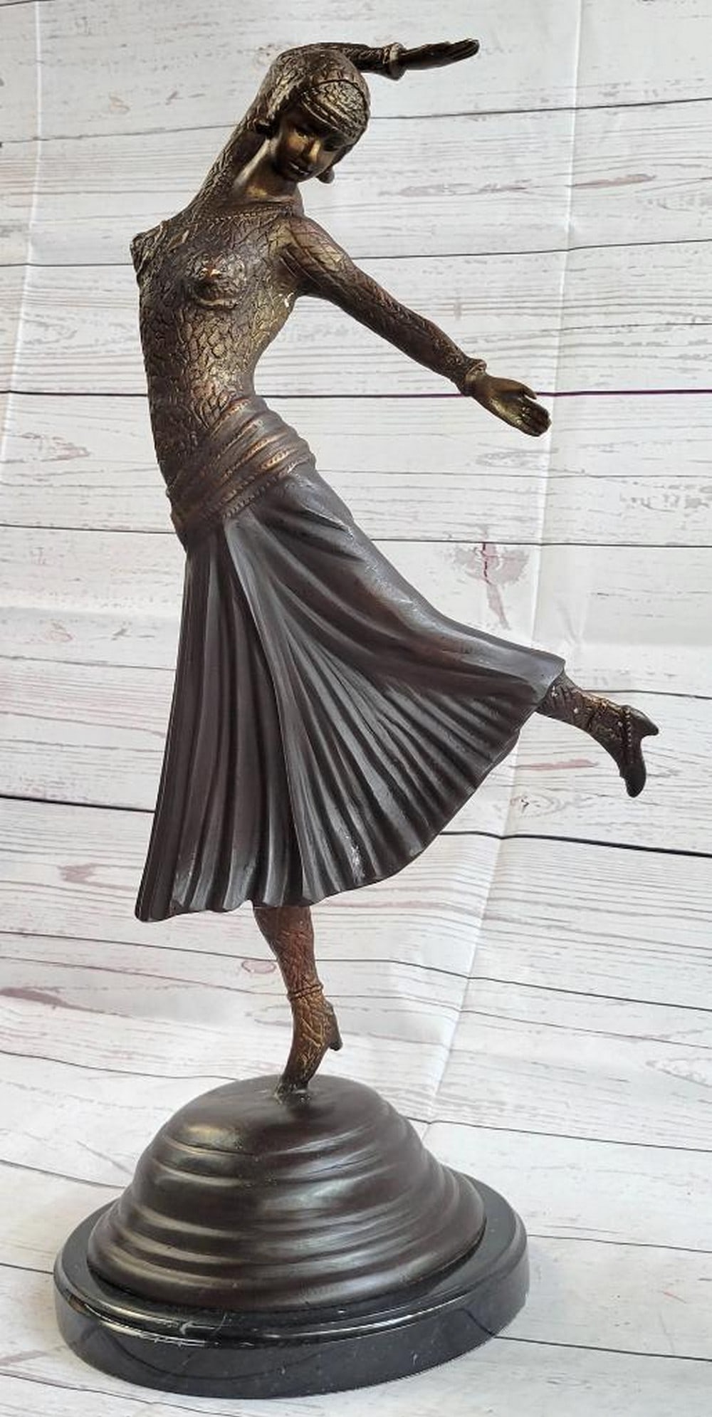 Russian Dancer Girl Bronze Sculpture: Russian Dancer Girl Bronze Sculpture With grace, agility and flexibility, this vibrant dancer is light on her toes. This dancer stands on her right foot, as she shimmy's across the stage. Her lon