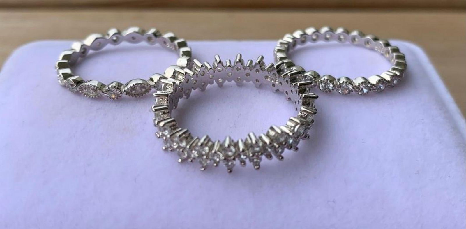 Set of 3 Silver-Tone Bands with Sparkling Floral & Geometric Accents: Set of 3 Silver-Tone Bands with Sparkling Floral & Geometric Accents Add a touch of charm and versatility to your jewelry collection with this stunning set of three silver-tone ring bands. Each b