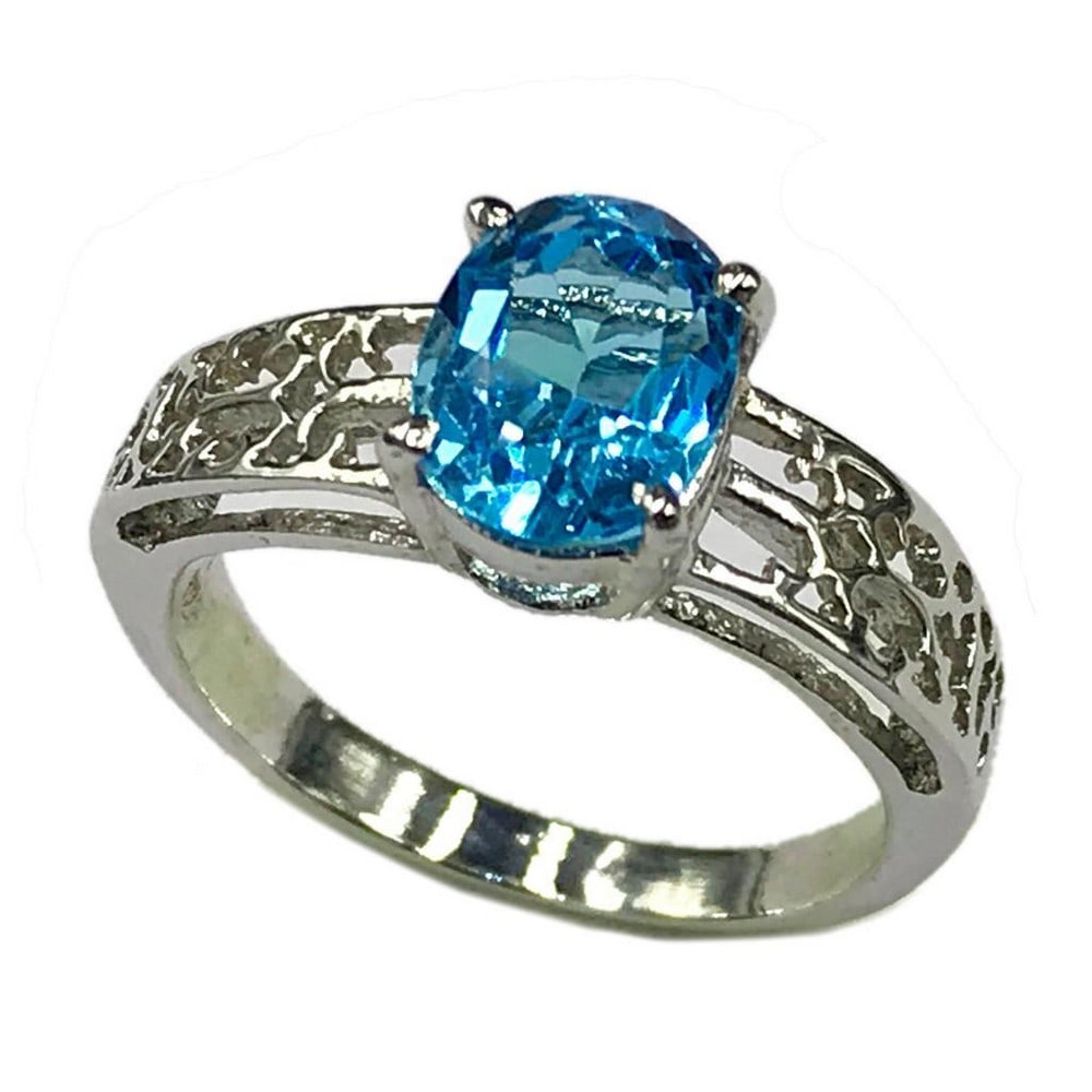 Large Blue Topaz Gemstone on an Intricate 925 Sterling Silver Band: Large Blue Topaz Gemstone on an Intricate 925 Sterling Silver Band. Blue topaz represents love and affection. It is believed to give the wearer increased strength and intellect. Through the