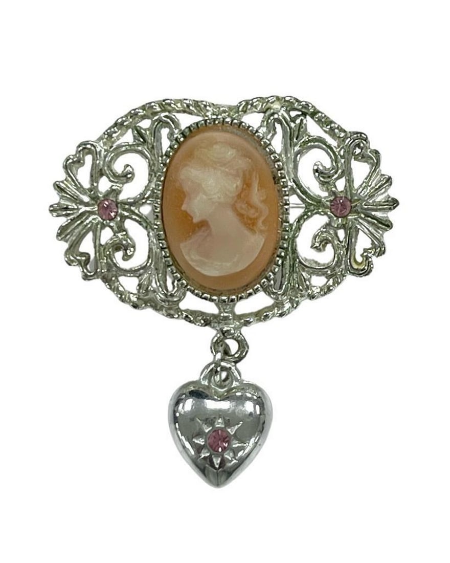 Whimsical Heart and Coral Hues Silver Cameo Brooch: Whimsical Heart and Coral Hues Silver Cameo Brooch Embrace the enchantment of our Whimsical Coral Hues Silver Cameo Brooch. Meticulously designed, this piece captures the essence of romance,