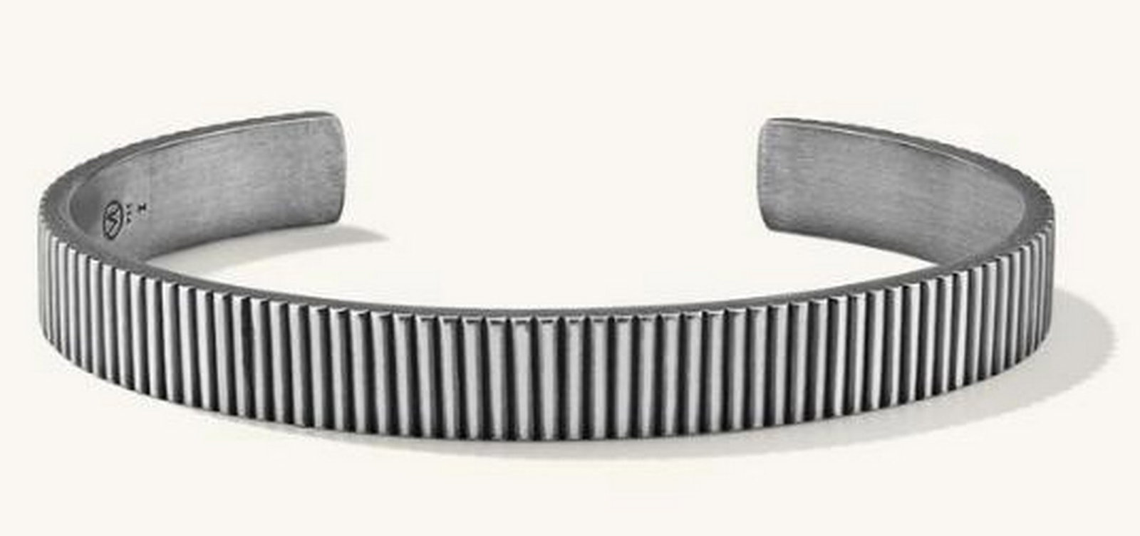 Timeless Edge Cuff: Timeless Edge Cuff This is a bold and striking piece that blends modern design with a vintage-inspired finish. Crafted from oxidized sterling silver, this cuff features a unique ribbed texture that a
