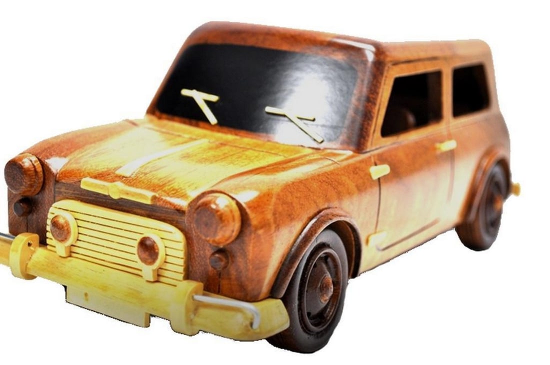 Mini Cooper Wooden Model: Mini Cooper Wooden Model Experience the charm and elegance of the iconic Mini Cooper with our meticulously crafted Wooden Model, made from exquisite mahogany wood. This miniature replica captures the