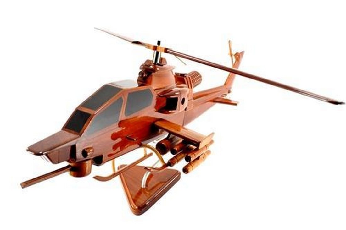 AH-1 Cobra Helicopter: AH-1 Cobra Helicopter This is a Bell AH-1 Cobra, a two-bladed, single engine attack helicopter manufactured by Bell Helicopter. It is hand crafted from solid mahogany and detailed with rockets,