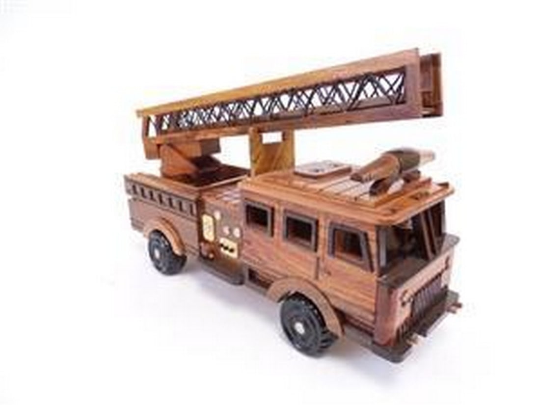 Fire Truck: Fire Truck The Fire Truck is beautifully recreated in this handcrafted scale model. Made of solid mahogany and finely detailed, this truck in a clear polyurethane high gloss finish has deep wood