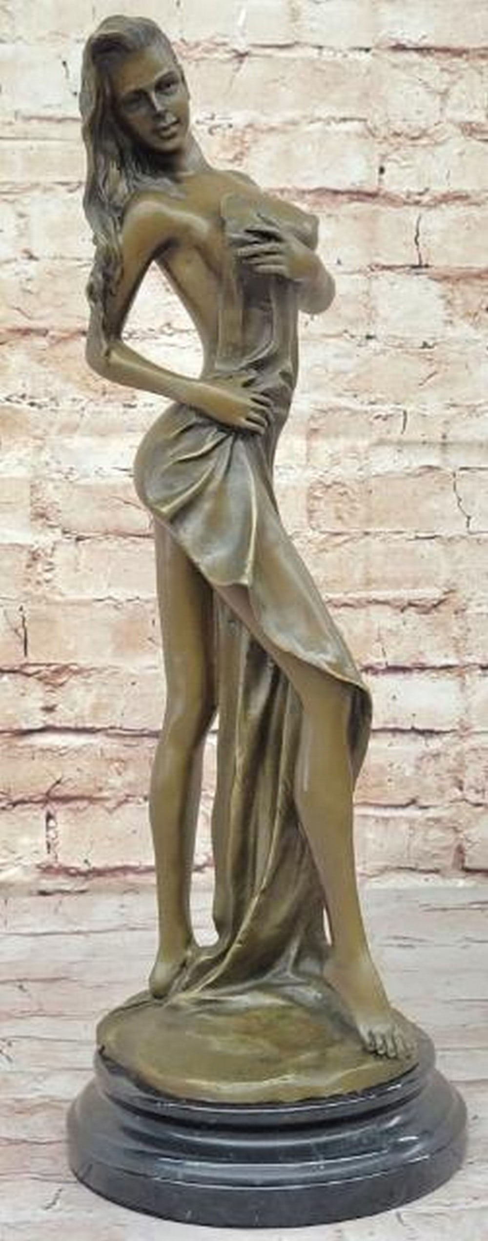 Nude Woman with Towel Bronze Sculpture: Nude Woman with Towel Bronze Sculpture Elegant and sensual, this bronze sculpture depicts a nude woman in a softly turned pose, her body partially draped with a towel that cascades over one side, sub