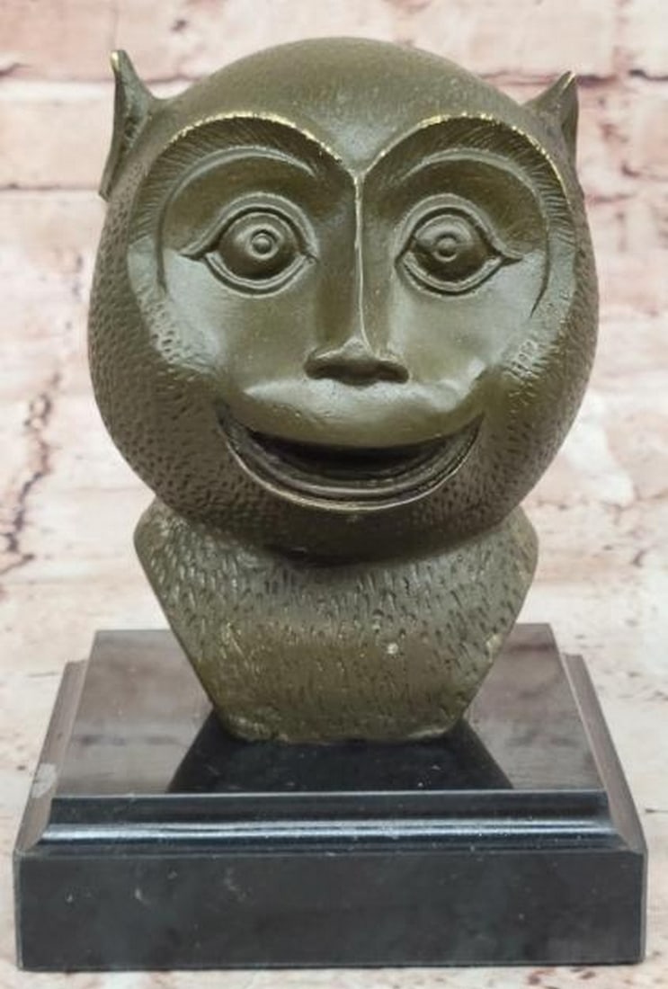 Playful Wisdom: Abstract Bronze Monkey Bust on Marble Base: Playful Wisdom: Abstract Bronze Monkey Bust on Marble Base Whimsical yet refined, this abstract bronze sculpture captures the joyful spirit of a smiling primate with modern artistic flair. The styliz