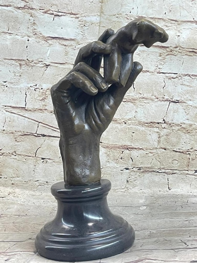 Work Hand Holding Nude Female Torso Inspired Bronze Statue - 11" x 6": Work Hand Holding Nude Female Torso Inspired Bronze Statue - 11" x 6" This sculpture, featuring a nude female torso delicately cradled by Rodin’s immense hand, was crafted in collaboration