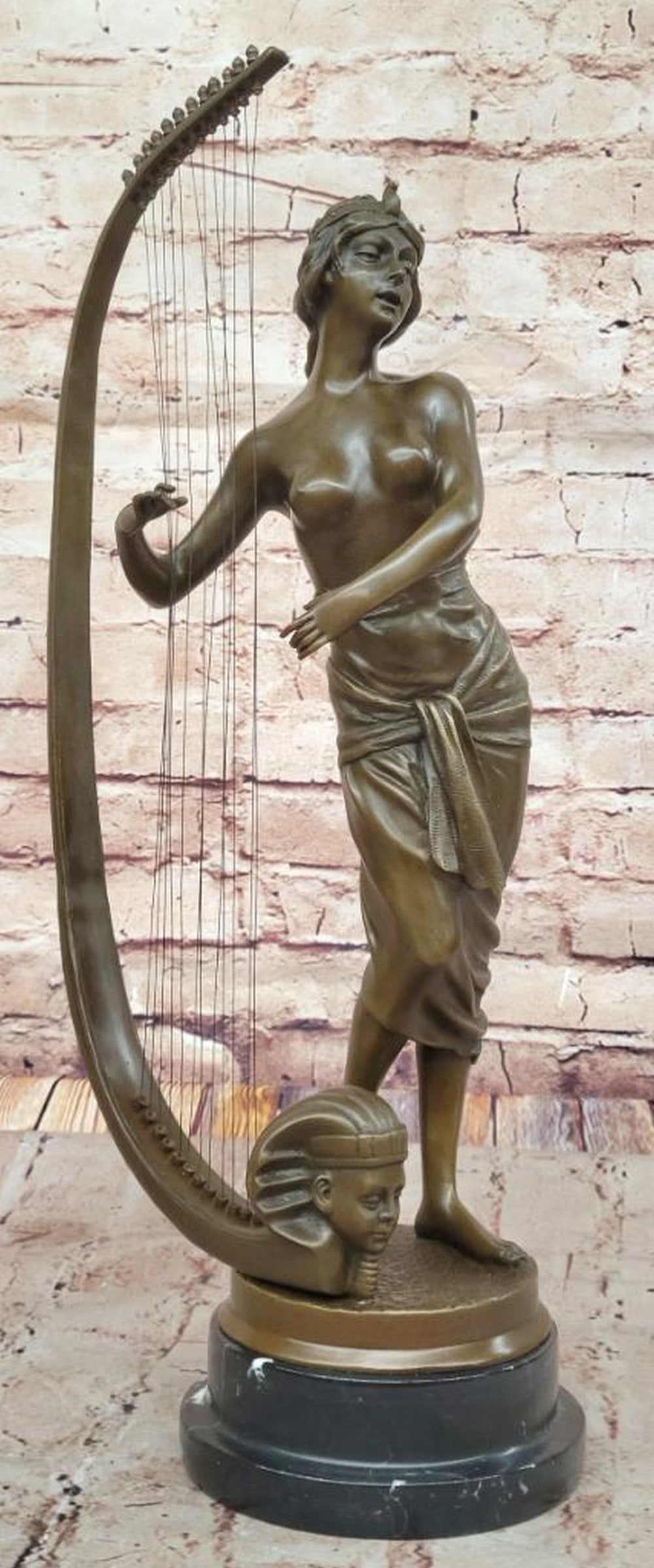 Egyptian Harpist Bronze Sculpture Inspired by Coudray - 19.5" x 8": Egyptian Harpist Bronze Sculpture Inspired by Coudray - 19.5" x 8" This elegant bronze sculpture by Coudray captures the grace of an Egyptian lady playing the harp, a tribute to ancient music