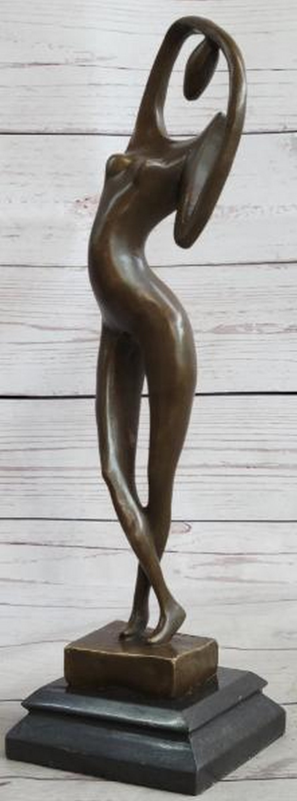 Abstract Bronze Nude Female: Abstract Bronze Nude Female An elegant and fluid modern art bronze sculpture depicting a stylized nude female figure caught in a moment of upward stretch. Crafted in hot cast bronze and set atop a so