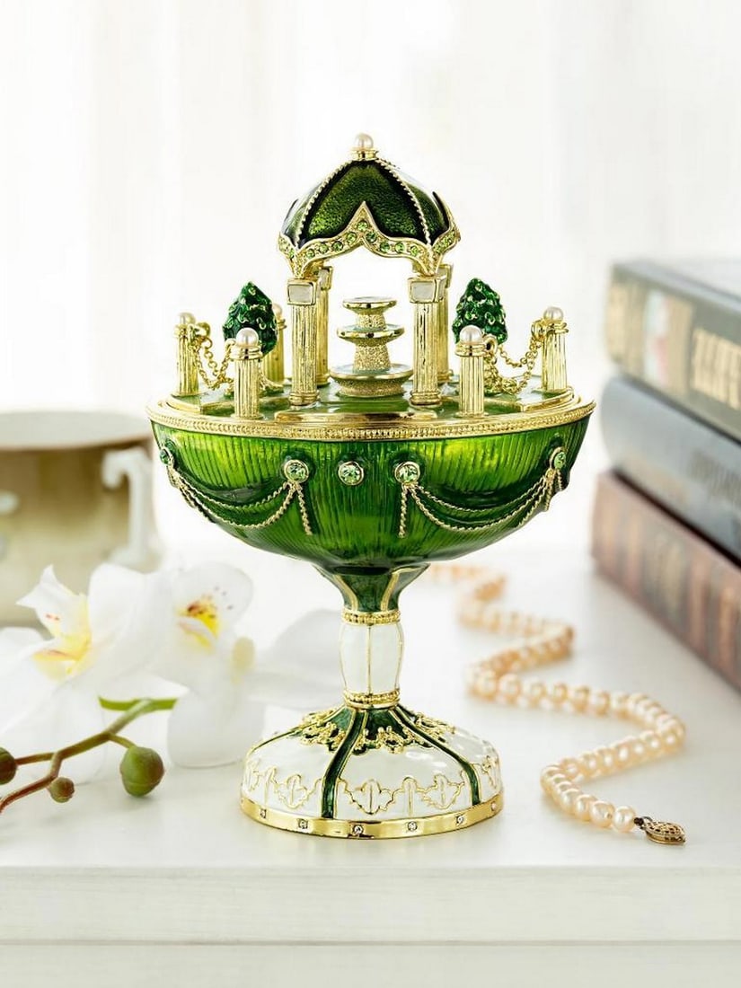 Garden Pavilion Egg Trinket Box 24K Gold Plated: Garden Pavilion Egg Trinket Box 24K Gold Plated This enamel-painted trinket box is designed in the shape of an ornate egg with a sculpted cupola and a small fountain motif. It is handcrafted and plate