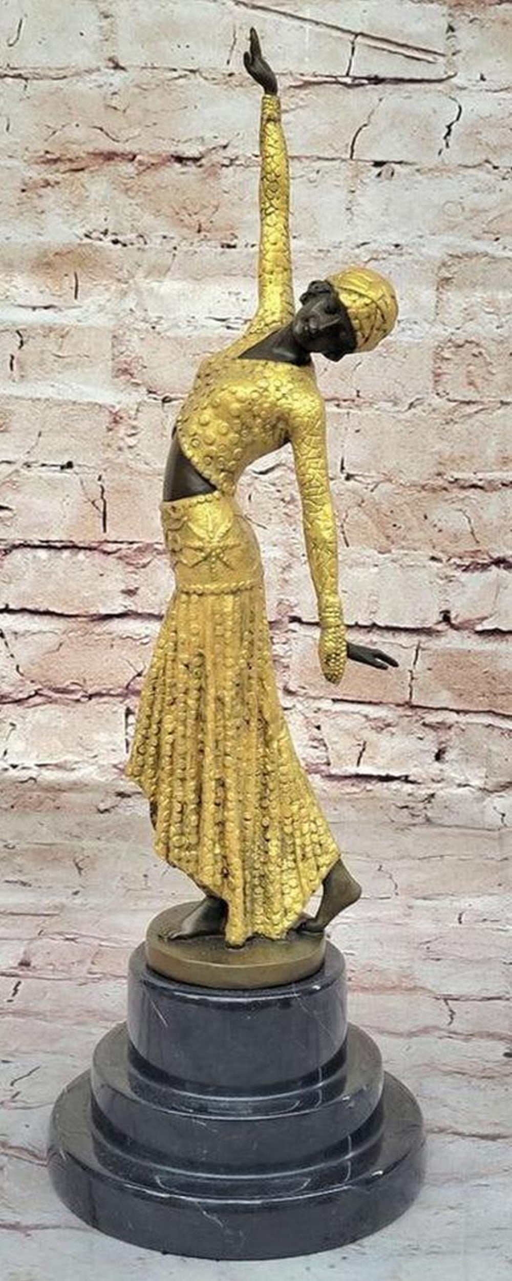 Egyptian Female Dancer Inspired Bronze Statue - 15" x 5": Egyptian Female Dancer Bronze Statue - 15" x 5" This bronze sculpture captures a serene moment with a tranquil woman in contemplation. Seated gracefully on an elegant chair, she gazes downwa