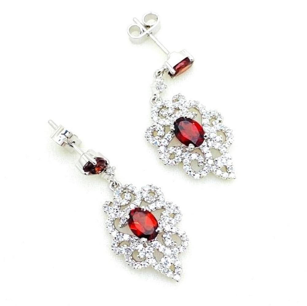 Garnet Middle Leaf Shape Earrings: Garnet Middle Leaf Shape Earrings These earrings feature a red garnet stone in the middle of a zirconia design with one also at the front of the stud. View Photos For Further Details